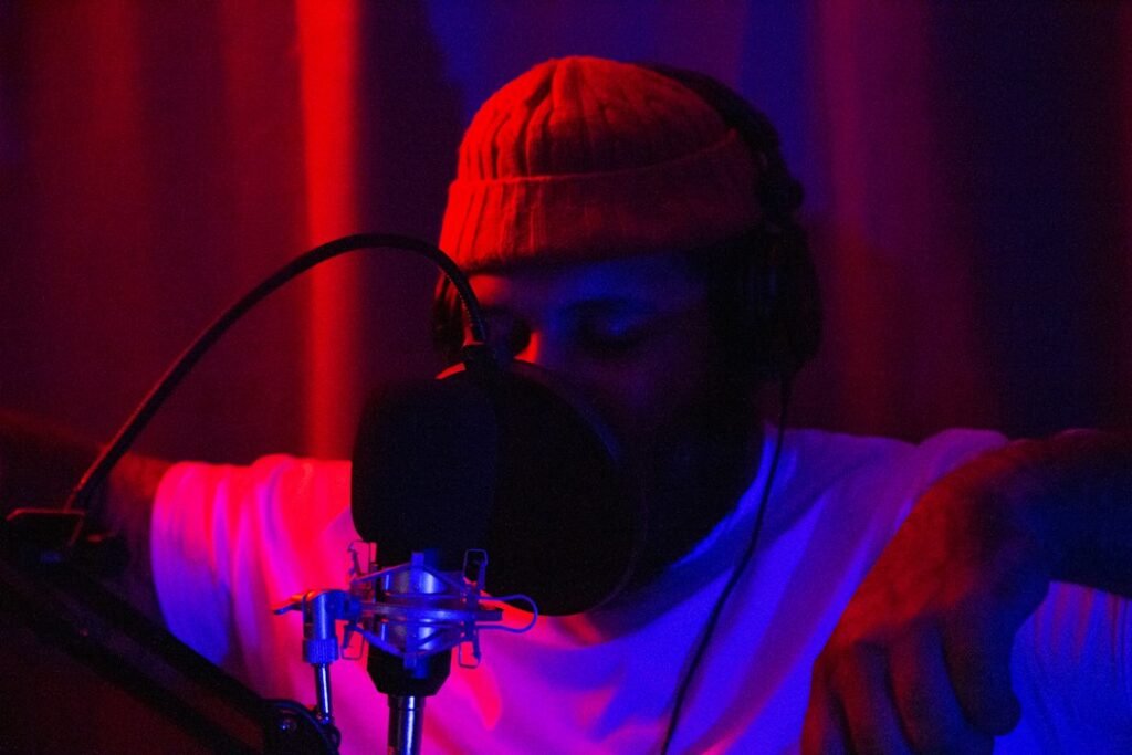 Donzy Featuring Abochi: What Listeners Should Know About “No Sad Days” 10 Musician recording vocals in a studio