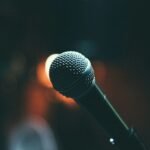 Singer performing with a microphone on stage