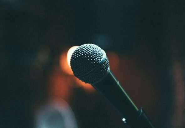 Singer performing with a microphone on stage